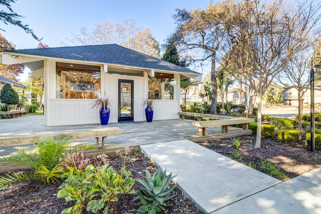 A house with a porch and a bench in front of it.