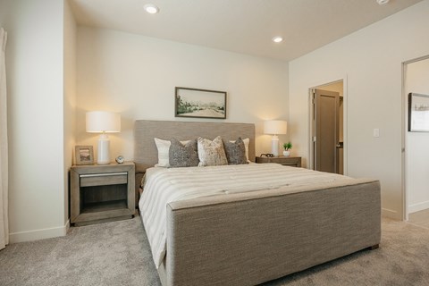 Large bed and nightstands in a model unit at Rise townhomes for rent in South Jordan, Utah.