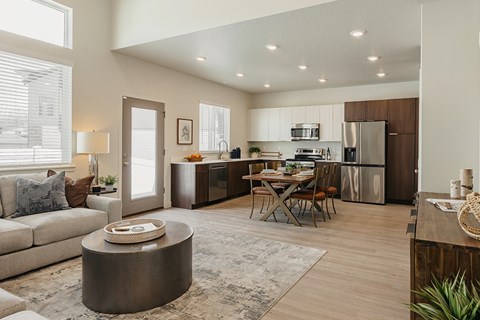 A modern kitchen with a dining table and chairs.