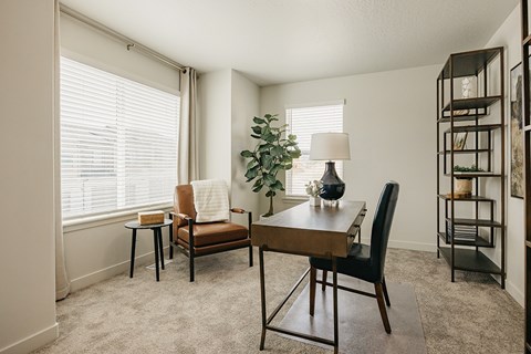 A living room with a brown chair and a wooden table.