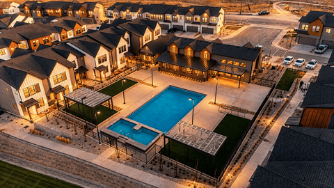 A large residential complex with a swimming pool.