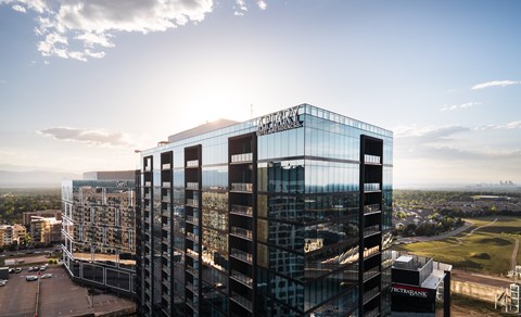 A tall glass building with the name "TECHNORAY" on the top.