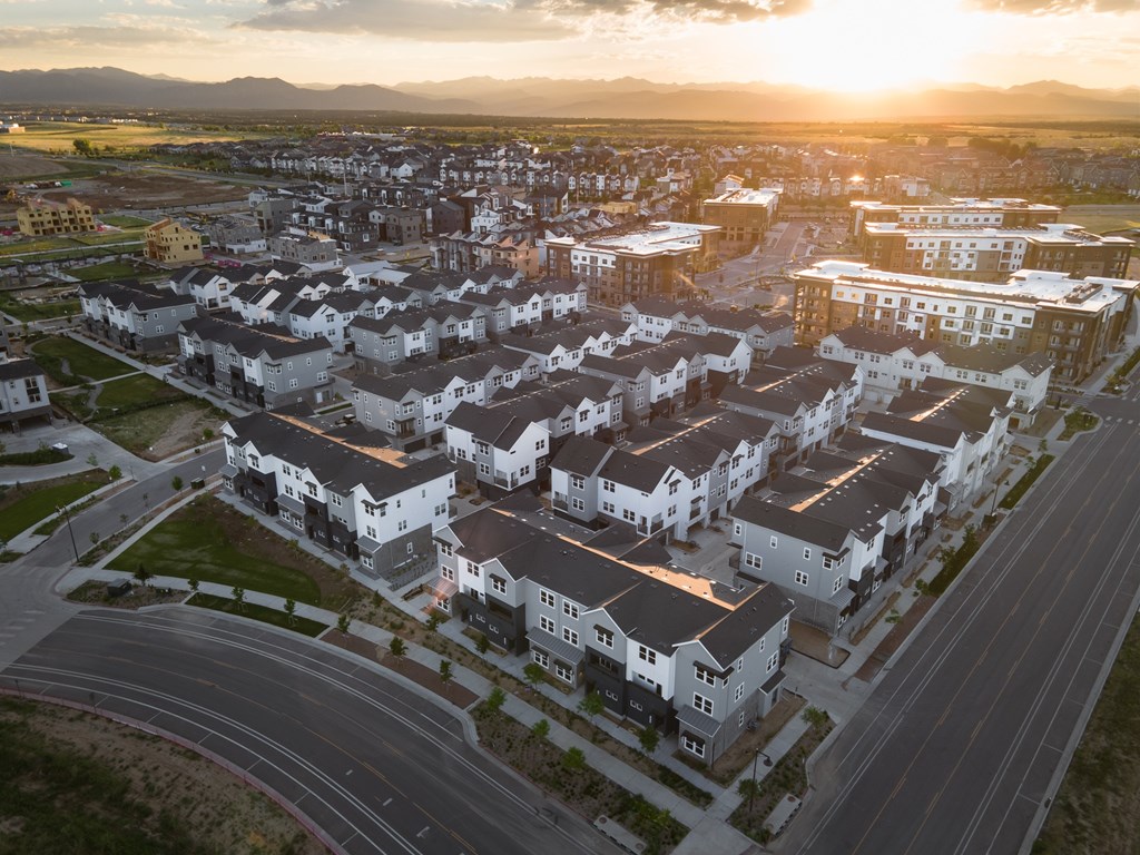 A sunset view of a residential area with houses and streets.