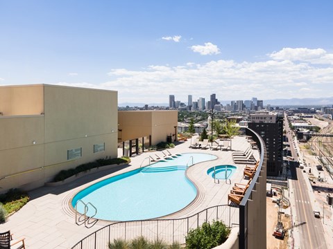 A swimming pool is located on the roof of a building.