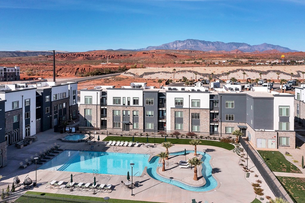 an aerial view of an apartment complex with a large swimming pool