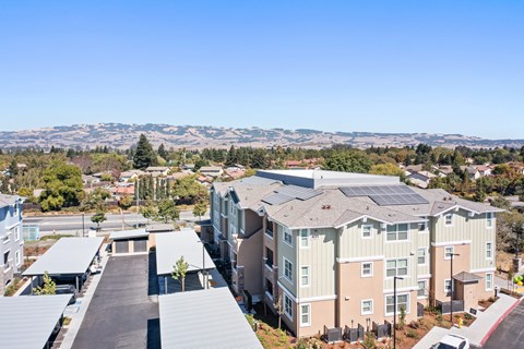 an aerial view of an apartment community with mountains in the background