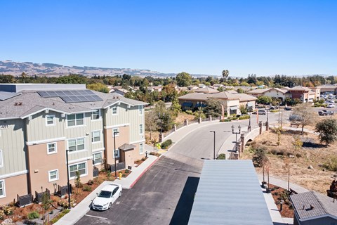an aerial view of a neighborhood with houses and a road