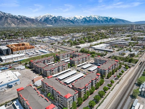 A large building complex with a mountain range in the background.