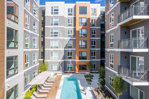 an apartment building with a pool in the middle