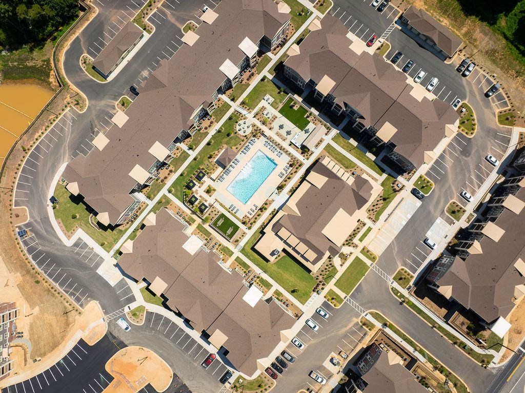an aerial view of a neighborhood with houses and a pool