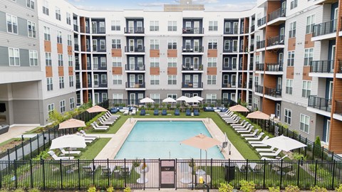 a swimming pool in front of an apartment building