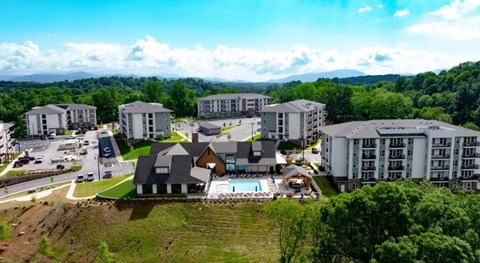A large building complex with a swimming pool in the foreground.