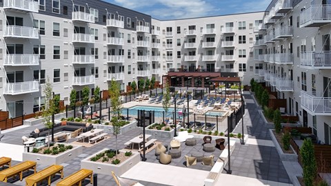 A large courtyard with a pool surrounded by apartment buildings at The Hallon Hennepin apartments in Minneapolis.