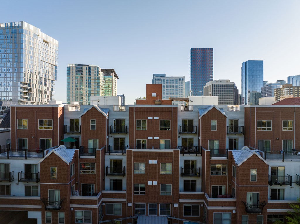 Apartment buildings in a city with tall buildings in the background.