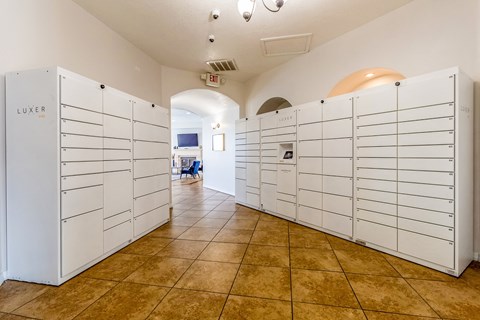a bunch of white lockers in a room with a tile floor