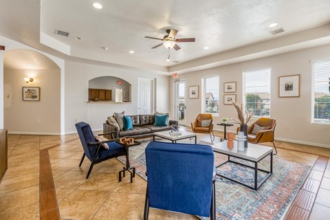 a living room with furniture and a ceiling fan