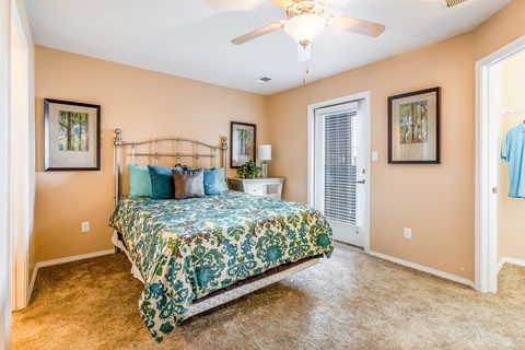 a bedroom with a bed and a ceiling fan
