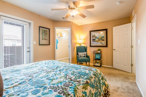 a bedroom with a large bed and a ceiling fan