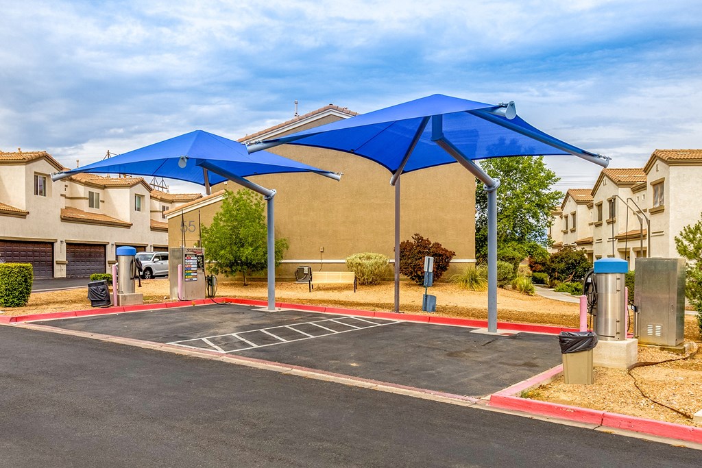 an empty parking lot with blue umbrellas in a parking lot