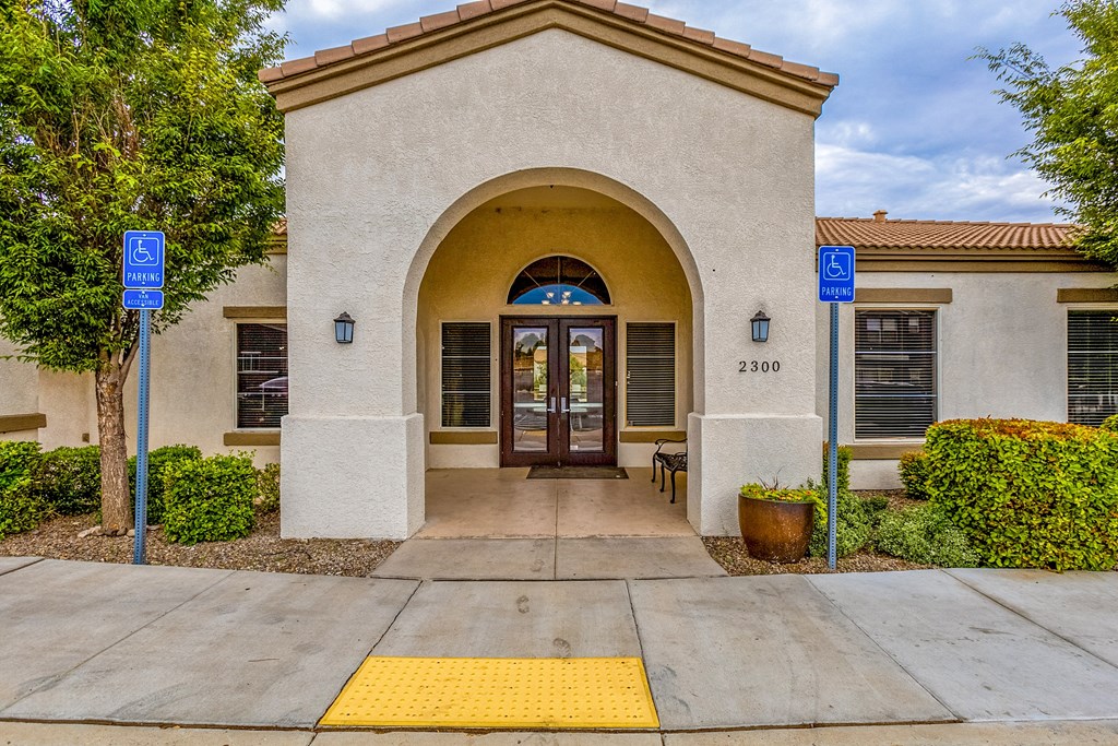 the front door of a building with two blue signs on either side of the door