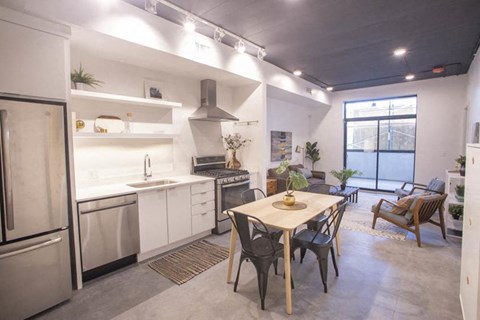 a kitchen and dining room with a table and chairs