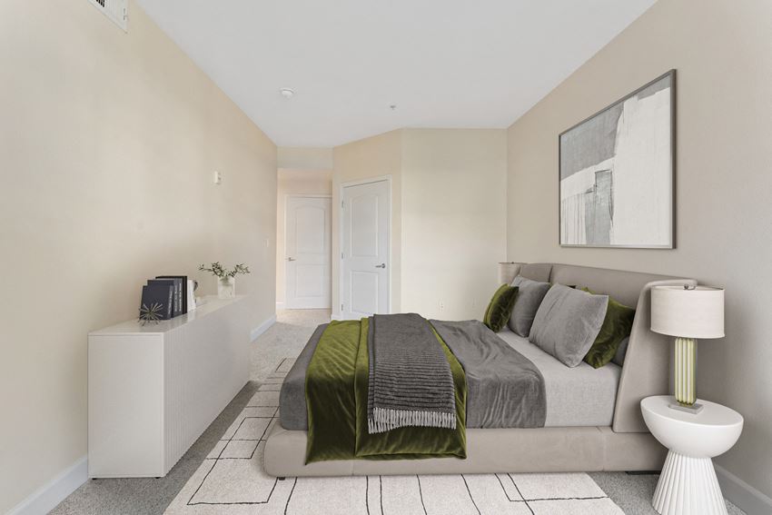a bedroom with a bed and a dresser and a bathroom