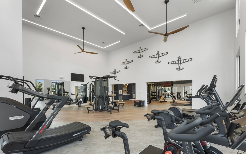 A gym with treadmills, exercise bikes and other equipment.