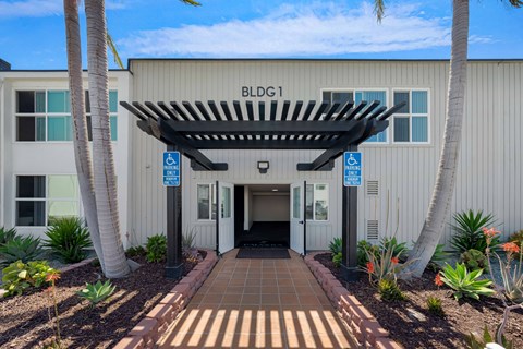 The image shows a building entrance with a sign that reads "BLDG1".