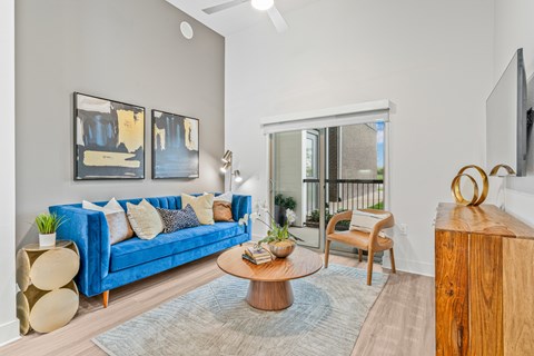 A living room with a blue couch and a coffee table.