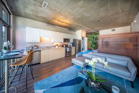 A modern kitchen with a dining table and chairs.