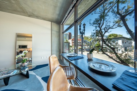A modern dining room with a view of the city.