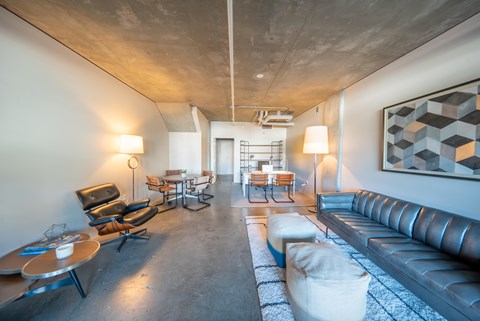 A modern living room with a long couch and a coffee table.