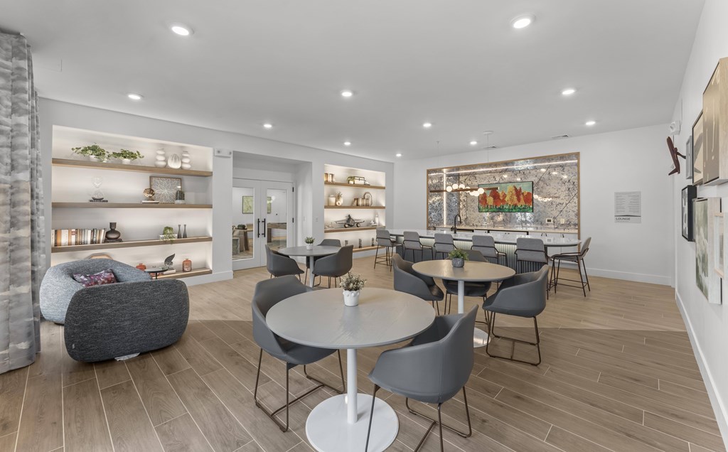 A modern dining area with grey chairs and a white table.