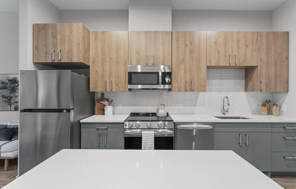 A modern kitchen with wooden cabinets and stainless steel appliances.