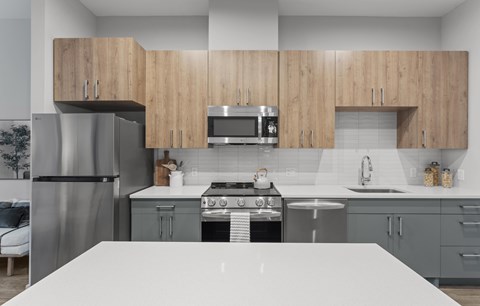A modern kitchen with wooden cabinets and stainless steel appliances.
