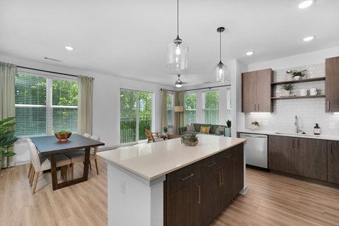 A modern kitchen with a dining table and chairs.