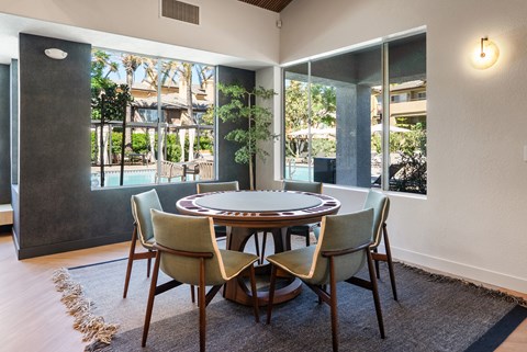 A dining room with a round table and chairs.