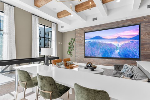 A modern living room with a large flat screen TV mounted on a wooden wall.