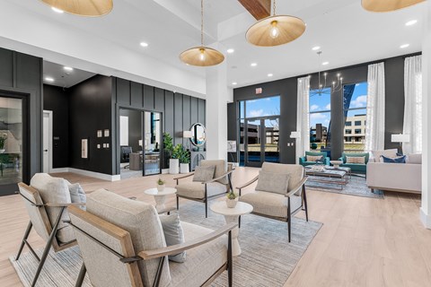 A spacious living room with a variety of seating options and a view of the city.