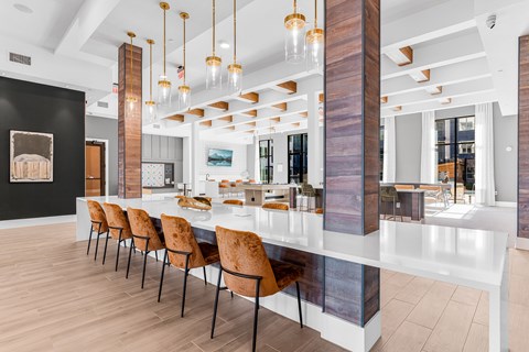 A long white table with chairs on it.