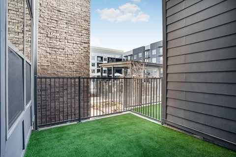 A small fenced in yard with a green lawn.