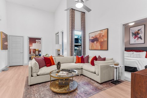 A living room with a beige couch and a coffee table.