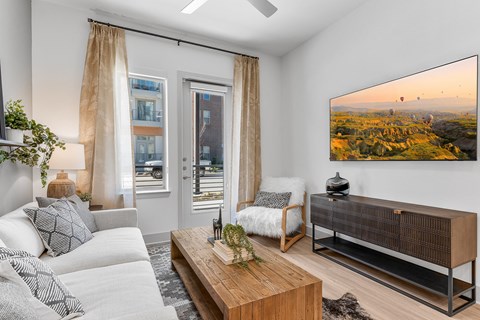 A living room with a large screen on the wall.