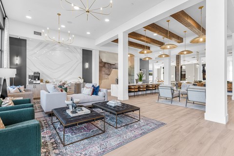 A modern living room with a dark wood coffee table and a large chandelier.