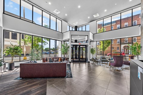 A large, modern lobby with a reception desk and seating area.