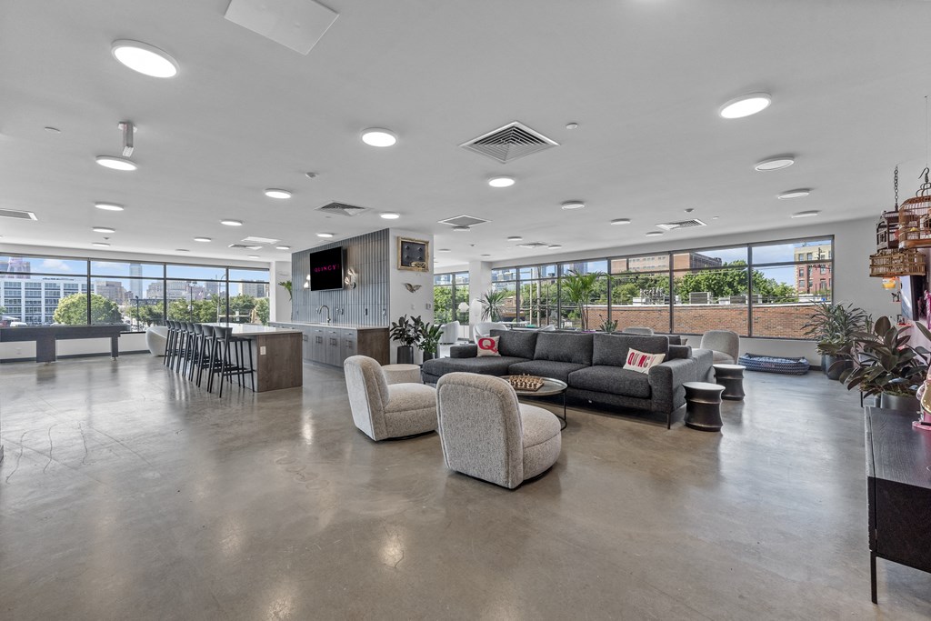 a living room filled with furniture and a large window