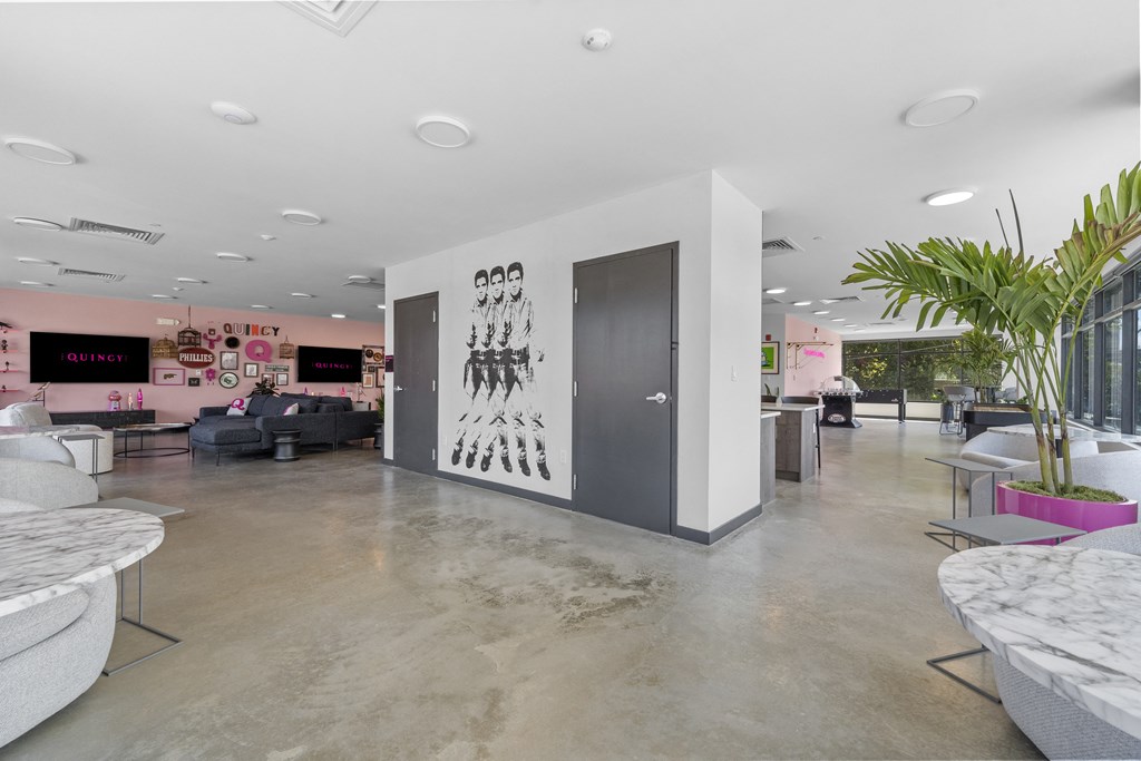 a view of the lobby at the opposite end of the building with couches and tables