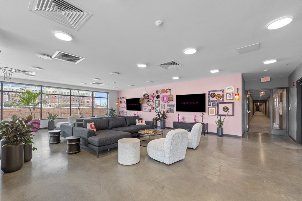 a living room filled with furniture and a large window