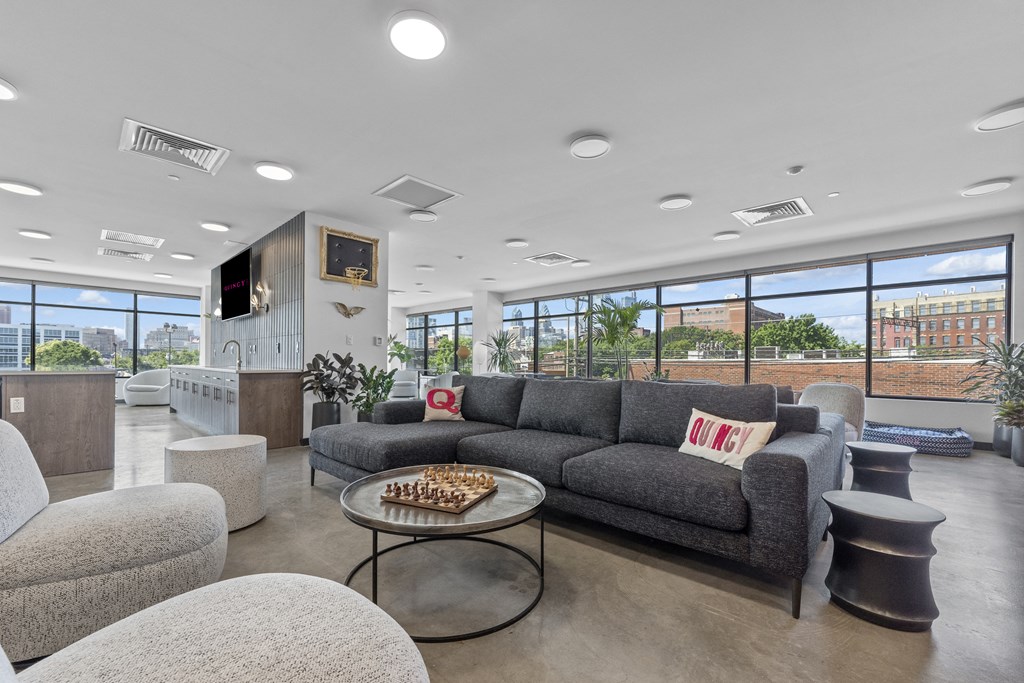 a living room filled with furniture and a large window