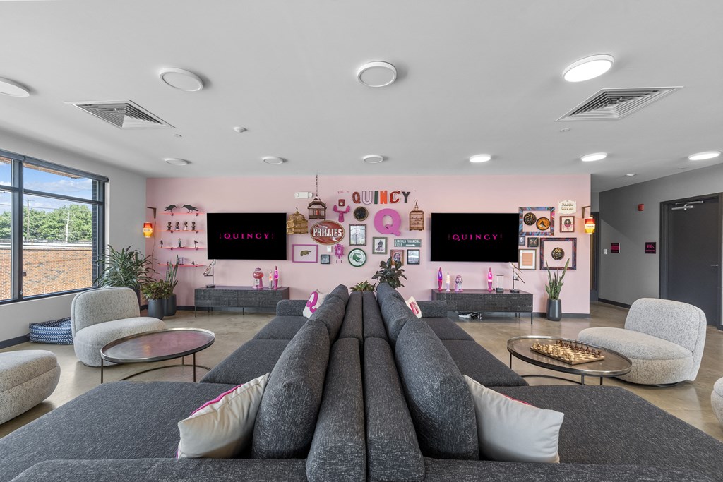 a living room filled with furniture and a large window